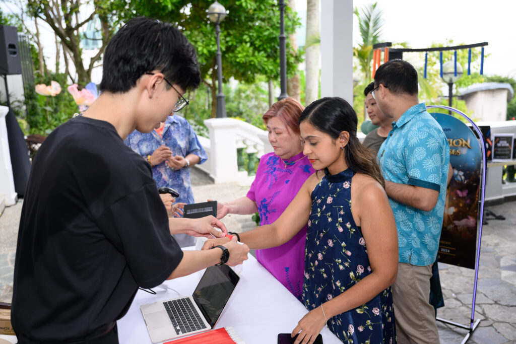 Wide venue shot of corporate dinner and dance event with stage setup and dramatic lighting